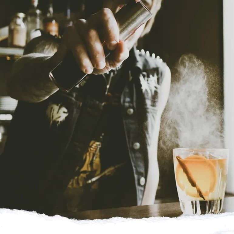 Man making a cocktail drink.