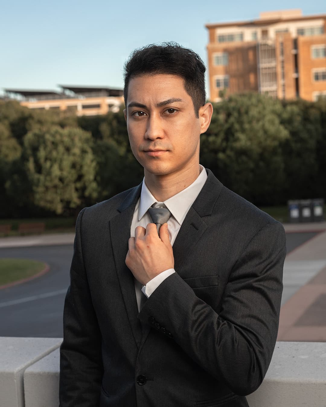 Added external flash during Golden Hour exposing for sky Man adjusting his suit tie during golden hour.
