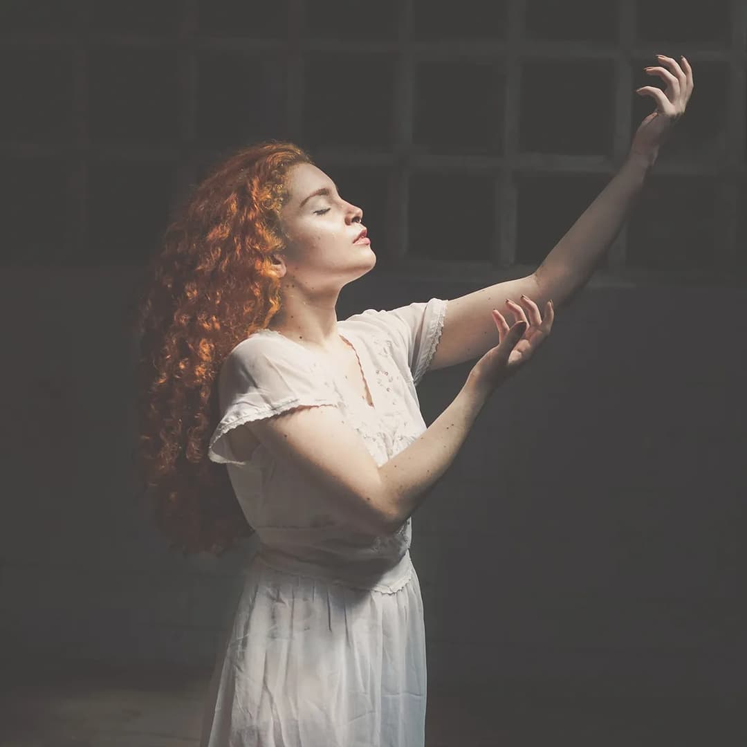 Woman holding up hands to the air.