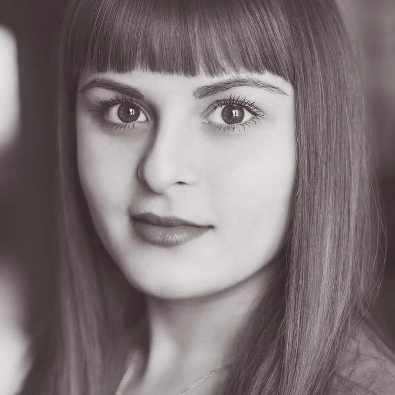 Woman looking at camera in black and white.