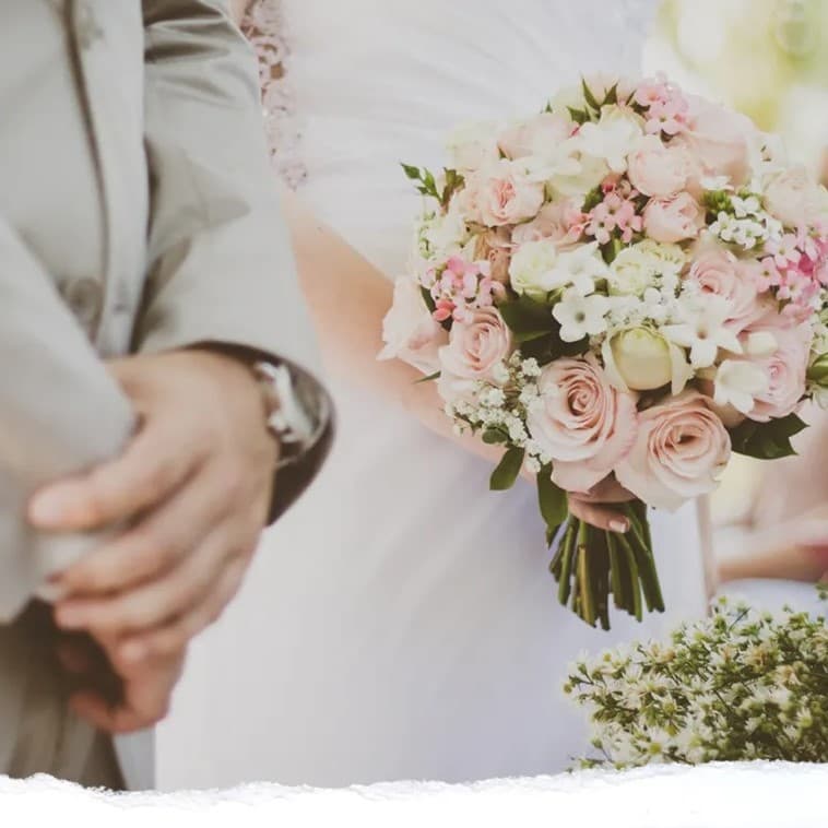 Hands of man and woman on wedding day.