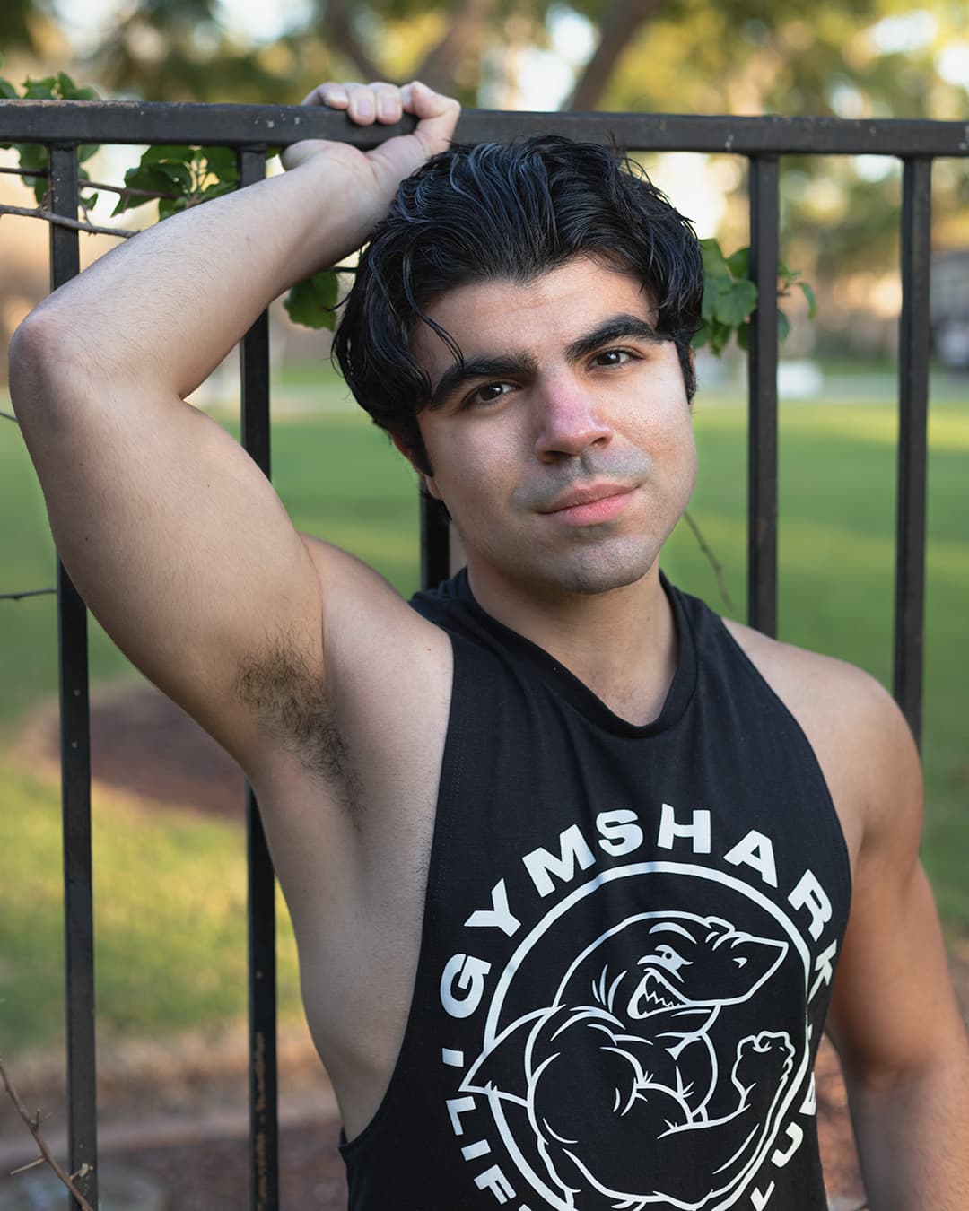 Example image using that strobe light for sharp photos Man against gate with lighting from strobe.