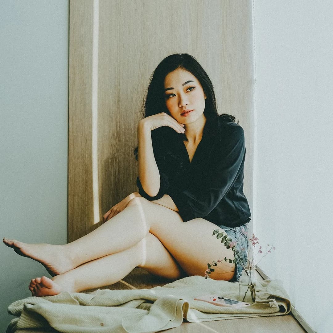Woman sitting near window.