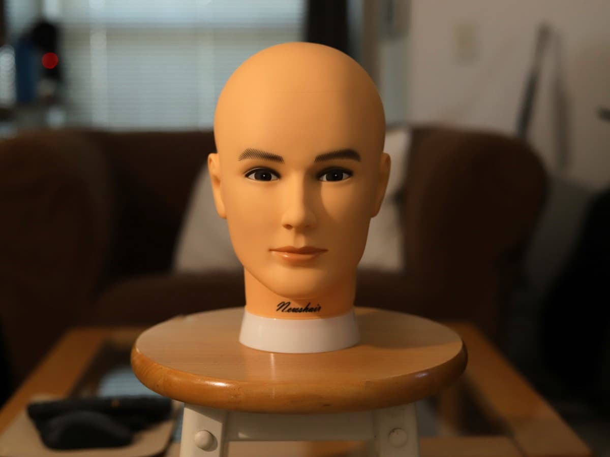 Image after adding shirt as diffuser Mannequin head on stool lit up with a speedlight with a diffuser.