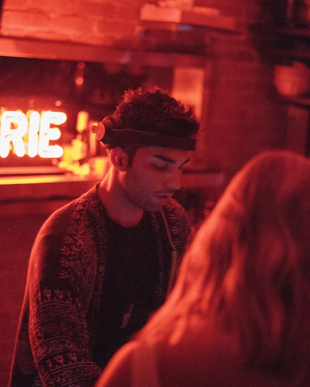 High ISO (High grain/noise) DJ in a bar.