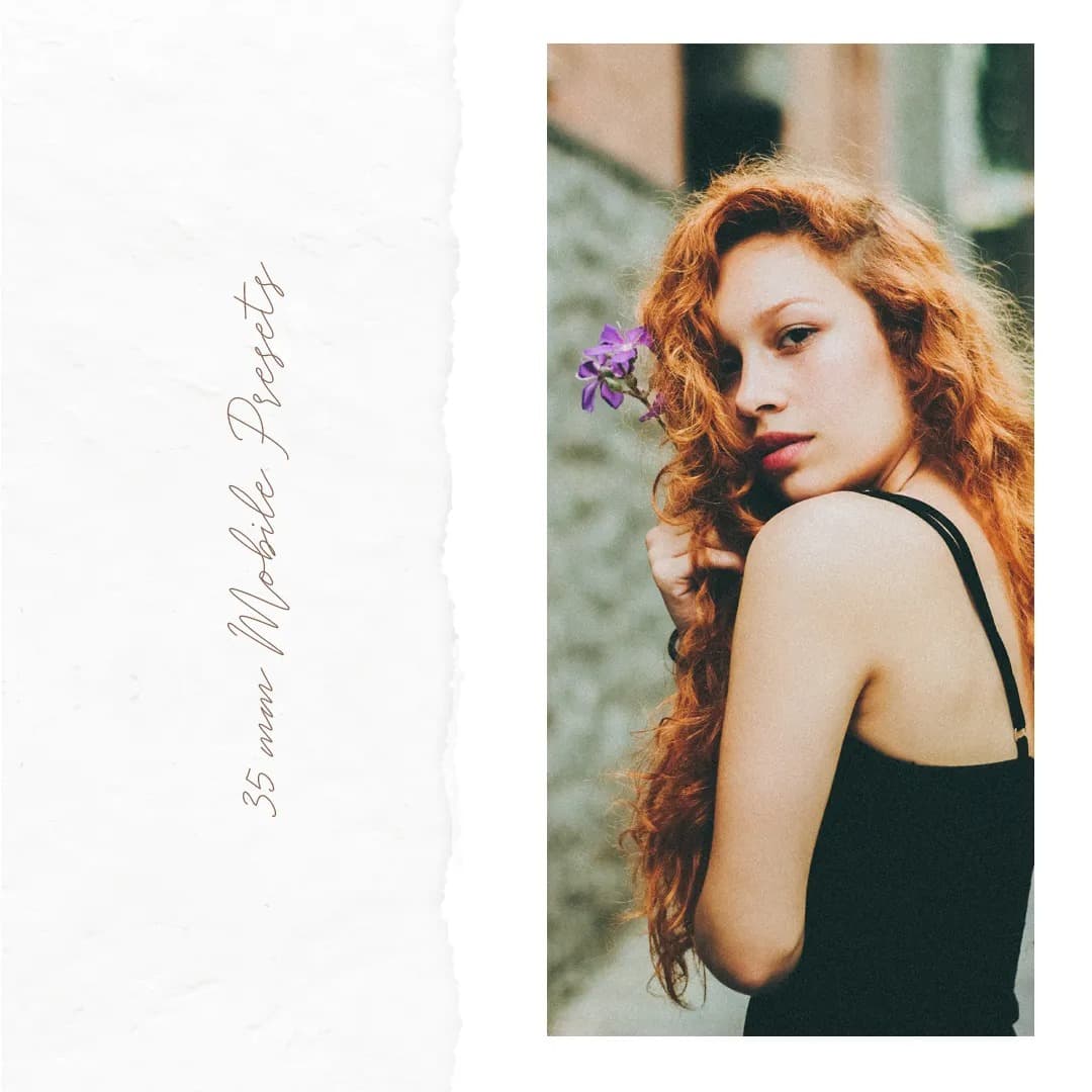 Red head woman standing with purple flower in hair.
