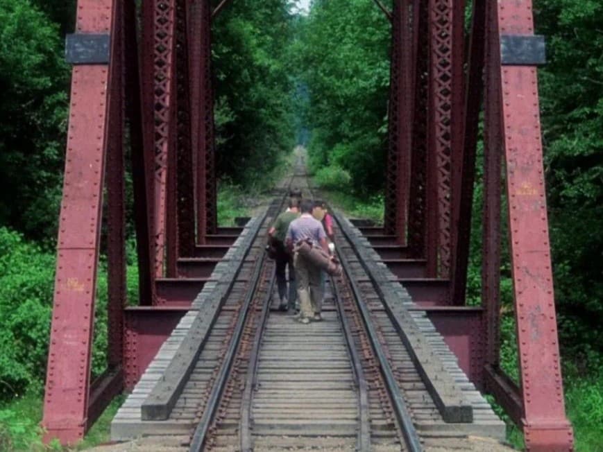 Leading lines in Stand by Me Scene from Stand by Me when kids are walking on train tracks that are leading lines.
