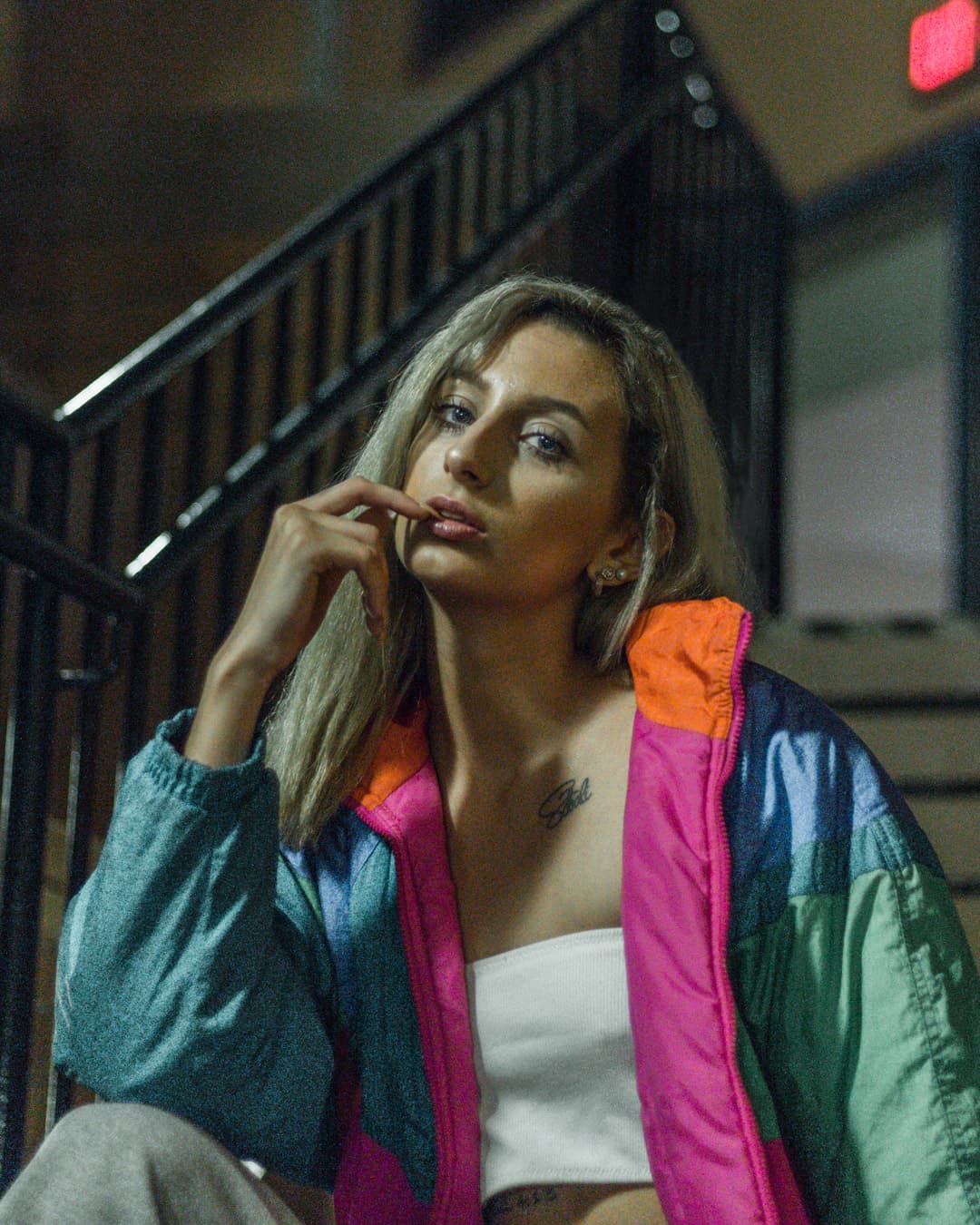 Luminance noise Girl sitting on staircase at night.
