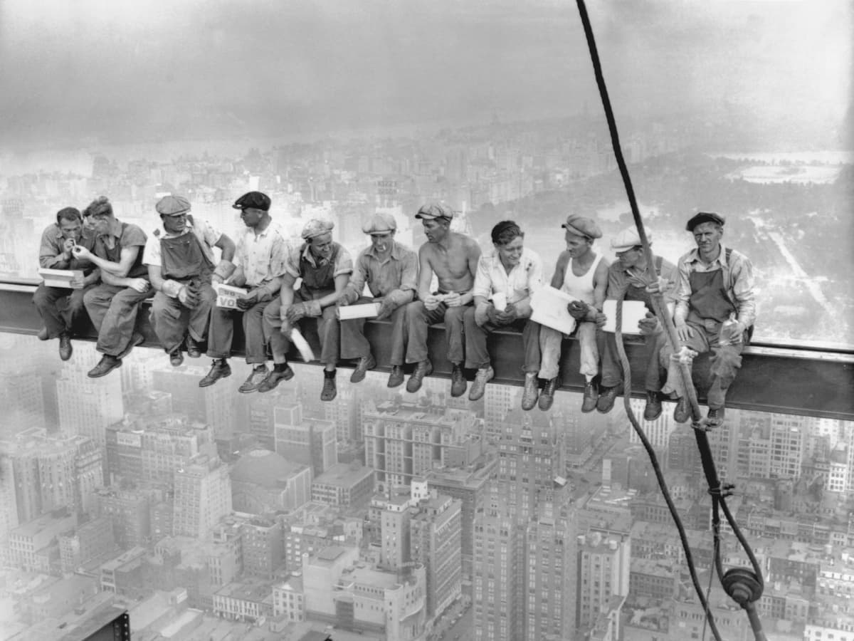 Lunch atop a Skyscraper by Charles C. Ebbets Men sitting in a line eating lunch on a skyscraper.
