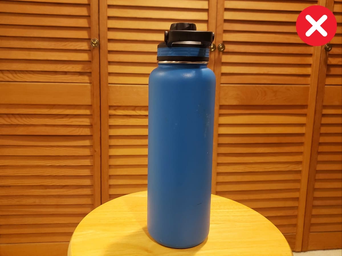 Not using framing Water bottle on a wooden stool not framed.