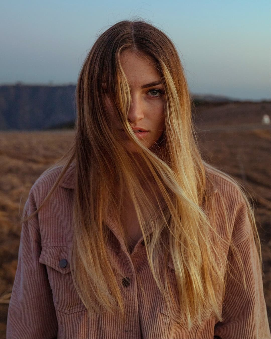 Portrait taken during blue hour Photo of girl with hair in her face during blue hour soft light.