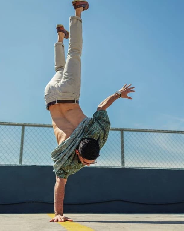 Using angles with leading liens Man doing handstand on leading line.