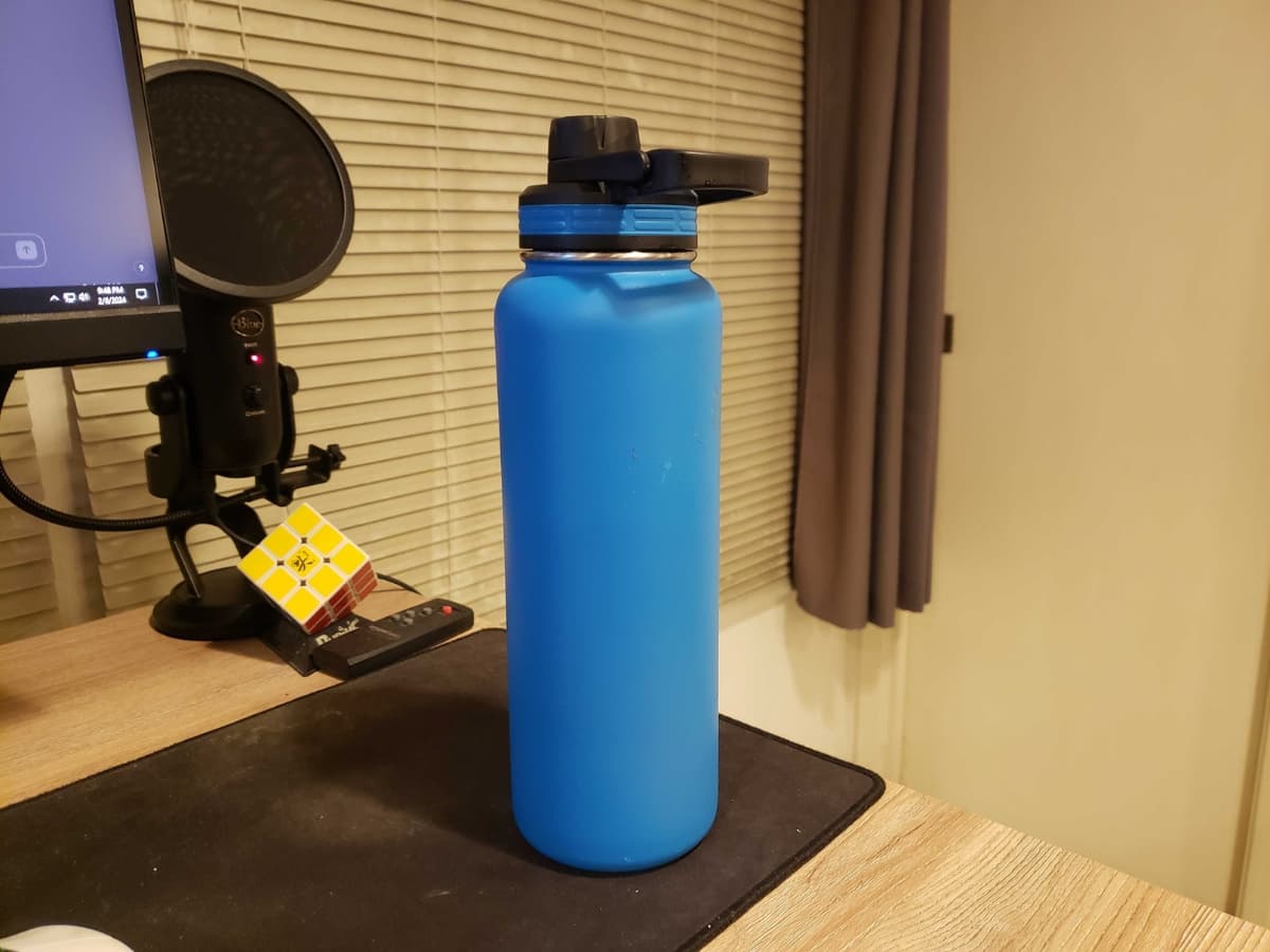 Using water bottle as my subject Water bottle on a desk.